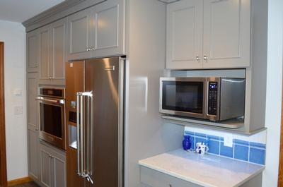 Broom closet, tall oven cabinet and fridge area work well together